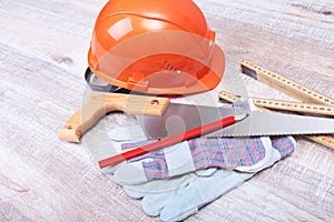 Orange hard hat, earplug, safety glasses and gloves for work. Earplug to reduce noise on a white background.