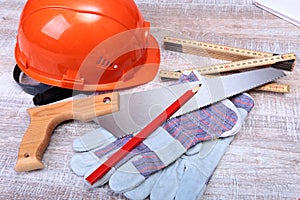 Orange hard hat, earplug, safety glasses and gloves for work. Earplug to reduce noise on a white background.