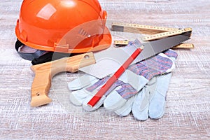 Orange hard hat, earplug, safety glasses and gloves for work. Earplug to reduce noise on a white background.