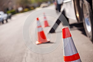 Orange Hazard Cones and Utility Truck in Street