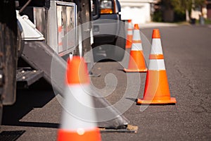 Orange Hazard Cones and Utility Truck in Street