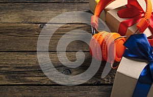 Orange headphones music audio, box with ribbon bow gift