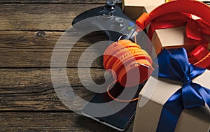 Orange headphones music audio, gamepad, smartphone, mobile phone, box with ribbon bow gift