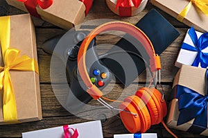 Orange headphones music audio, gamepad, smartphone, mobile phone, box with ribbon bow gift