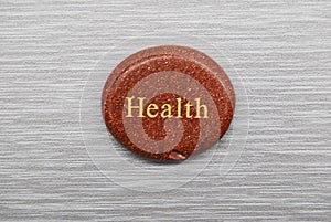 Orange health mood stone on gray background