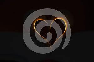 Orange heart shape with black background