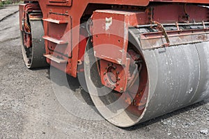 Orange Heavy Vibration roller compactor at asphalt pavement works for road repairing. Working on the new road