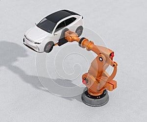 Orange heavyweight robotic arm delivering white SUV on concrete ground