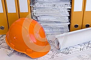 Orange helmet and project drawings