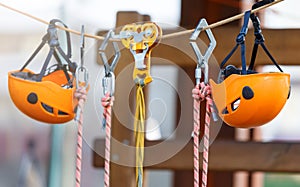 Orange Helmets and Strapping in the rope park. Adult and kids equipment for climbing in the adventure rope park. Active lifestyle