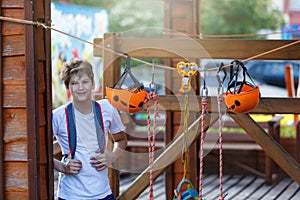 Orange Helmets and Strapping in the rope park. Adult and kids equipment for climbing in the adventure rope park. Active lifestyle