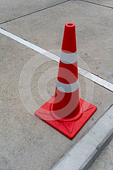 Orange highway traffic cones on concrete road