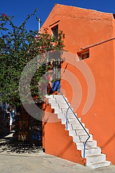 Orange house wall and white steps