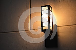 Orange incandescent light bulb mount on wall