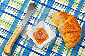 Orange jam and fresh croissant