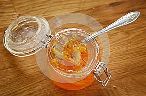 Orange jam in a glass jar. View from above