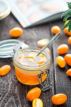 Orange Jam in Retro Jar with Recipe Book on the Background