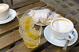 Orange juice, chocolate croissant, and a coffee coupe