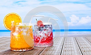 Orange juice in clear glass with ice cubes and Mocktail Strawberry Soda not mix alcohol. Fresh strawberries. Cold drinks placed on