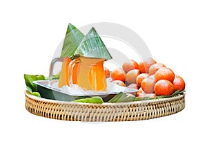 Orange juice in clear glass jar witih banana leaf , ice and  mandarin orange fruit on wood woven tray isolated on white background