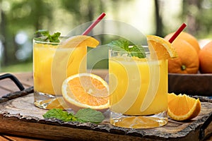 Orange juice cocktail with mint and orange slices