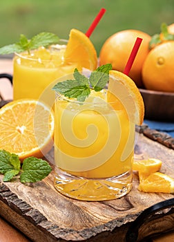Orange juice cocktail with mint and orange slices