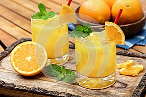 Orange juice cocktail with mint and orange slices