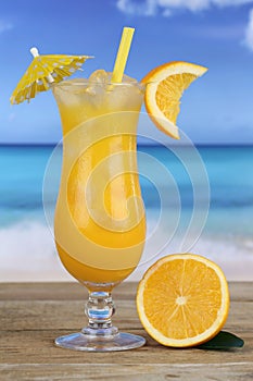 Orange juice fruit drink on the beach