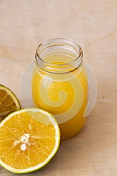 Orange juice in glass jar with fresh fruit