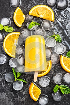 Orange juice homemade popsicle over ice