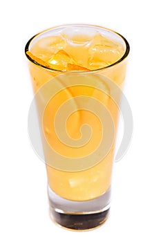 Orange juice with ice and orange pieces in a glass on an isolated white background