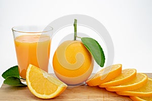 Orange juice and oranges with leaves