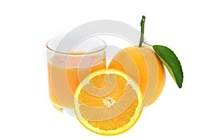 Orange juice and oranges with leaves