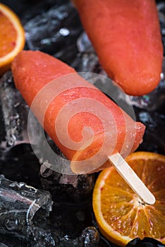Orange juice popsicles over ice
