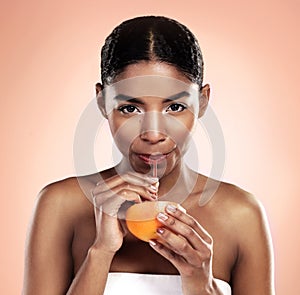 Orange, juice and portrait of woman in studio for vitamin c benefits in skincare or dermatology. Citrus, drink and fruit