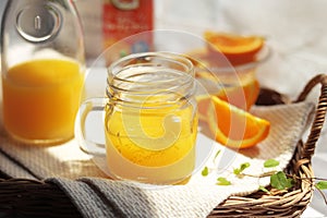 Orange juice poured into a mason jar mug cup