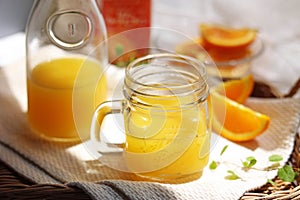 Orange juice poured into a mason jar mug cup