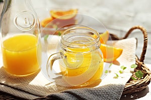 Orange juice poured into a mason jar mug cup