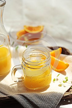 Orange juice poured into a mason jar mug cup