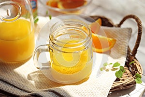 Orange juice poured into a mason jar mug cup