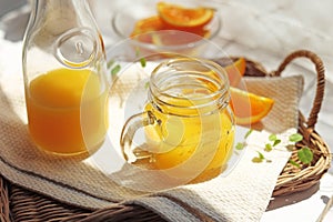 Orange juice poured into a mason jar mug cup