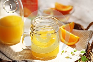 Orange juice poured into a mason jar mug cup