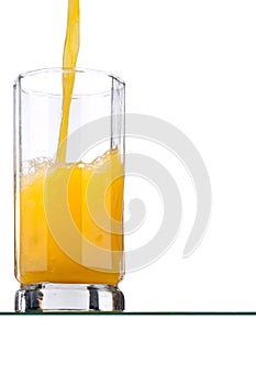 Orange juice poured into a tall glass