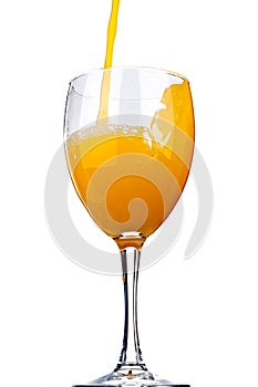 Orange juice poured into a wine glass