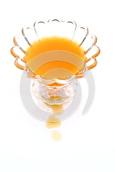 Orange juice pouring on white background