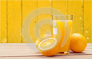 Orange juice and slices of orange on background