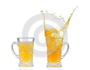 Orange juice splash in glass isolated on white