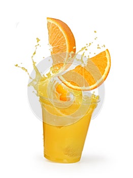 Orange juice splash with oranges in a plastic cup