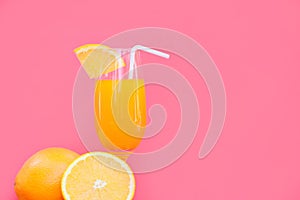 Orange juice summer glass piece orange fruit with red pink background
