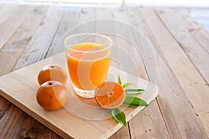 Orange juice on wooden background